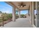 Covered balcony with ceiling fan and iron railing overlooks backyard and neighborhood at 7878 Brianna Cheerful Ave, Las Vegas, NV 89178