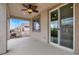 Covered balcony with ceiling fan and sliding glass doors overlooks backyard and neighborhood at 7878 Brianna Cheerful Ave, Las Vegas, NV 89178