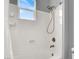 Clean white shower and tub combo features a showerhead and window for natural light at 7878 Brianna Cheerful Ave, Las Vegas, NV 89178