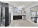 Modern bathroom with stone shower, dark wood cabinets, and ample counter space overlooking a neighboring room at 7878 Brianna Cheerful Ave, Las Vegas, NV 89178