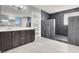 Modern bathroom featuring dark wood cabinets, a white countertop, and a spacious walk-in shower with dark tile at 7878 Brianna Cheerful Ave, Las Vegas, NV 89178