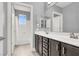 Bathroom with double vanity, large mirror, and shower/tub combo with window at 7878 Brianna Cheerful Ave, Las Vegas, NV 89178
