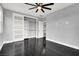Bedroom with ceiling fan and hardwood floors and a closet with sliding doors at 7878 Brianna Cheerful Ave, Las Vegas, NV 89178