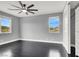 Bedroom with hardwood floors, two windows, ceiling fan, and large closet with sliding doors at 7878 Brianna Cheerful Ave, Las Vegas, NV 89178