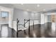 Upstairs hallway with hardwood floors, neutral walls, and staircase with decorative railings at 7878 Brianna Cheerful Ave, Las Vegas, NV 89178