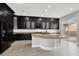Gourmet kitchen with dark cabinetry, granite island, and stainless appliances for modern living at 7878 Brianna Cheerful Ave, Las Vegas, NV 89178
