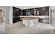 Modern kitchen featuring dark wood cabinets, granite countertops, and stainless steel appliances at 7878 Brianna Cheerful Ave, Las Vegas, NV 89178