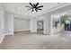 Open living space with tile floors, recessed lights, neutral walls, stairs and access to the outdoor patio at 7878 Brianna Cheerful Ave, Las Vegas, NV 89178