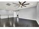 Spacious living room with hardwood floors, modern ceiling fan, and natural light, perfect for entertaining at 7878 Brianna Cheerful Ave, Las Vegas, NV 89178