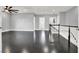 An open-concept loft area featuring dark wood floors, white trim, and abundant natural light, great for entertaining at 7878 Brianna Cheerful Ave, Las Vegas, NV 89178