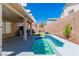 Backyard with a small pool, patio, privacy wall, and lush greenery at 7990 Timber Horn Ct, Las Vegas, NV 89147