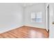 The bedroom has wood floors and a ceiling fan at 7990 Timber Horn Ct, Las Vegas, NV 89147