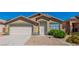 Charming single-story home featuring desert landscaping, a two-car garage, and a welcoming front entrance at 7990 Timber Horn Ct, Las Vegas, NV 89147