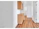 Hallway featuring cabinets, neutral paint, and wood floors at 7990 Timber Horn Ct, Las Vegas, NV 89147