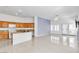 Open-concept kitchen with wood cabinets, granite countertops, and an adjacent living area, perfect for entertaining guests at 7990 Timber Horn Ct, Las Vegas, NV 89147