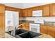 Close-up of a kitchen featuring wood cabinets, granite countertops, and stainless steel faucet, highlighting functionality at 7990 Timber Horn Ct, Las Vegas, NV 89147