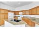 Bright kitchen with wood cabinets, white appliances, granite countertops, and a functional central island at 7990 Timber Horn Ct, Las Vegas, NV 89147