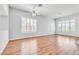 Spacious living room with wood floors, ceiling fan and lots of natural light from windows at 7990 Timber Horn Ct, Las Vegas, NV 89147