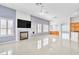 Open-concept living area boasts tile floors, a fireplace, plantation shutters, and ample natural light at 7990 Timber Horn Ct, Las Vegas, NV 89147