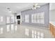 Bright living area with tile floors, plantation shutters, a fireplace, and access to the backyard at 7990 Timber Horn Ct, Las Vegas, NV 89147