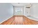 Living room with wood floors, neutral paint, and a large window at 7990 Timber Horn Ct, Las Vegas, NV 89147