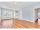 Open-concept living room with wood floors and lots of natural light from windows and entry door at 7990 Timber Horn Ct, Las Vegas, NV 89147