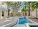 Relaxing backyard oasis featuring dual water fountains, and lush palm trees at 8051 Castle Pines Ave, Las Vegas, NV 89113