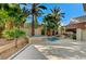 Backyard oasis showcasing lush palms, decorative fountains, and spacious patio at 8051 Castle Pines Ave, Las Vegas, NV 89113