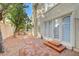 Backyard view with manicured landscaping, a stone pathway, and serene garden access at 8051 Castle Pines Ave, Las Vegas, NV 89113
