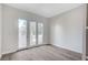 Light-filled room with balcony access and beautiful wood flooring at 8051 Castle Pines Ave, Las Vegas, NV 89113