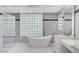 Bright bathroom featuring a freestanding tub and glass block window at 8051 Castle Pines Ave, Las Vegas, NV 89113