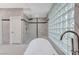 Stylish bathroom featuring a glass shower and free-standing tub with marble accents at 8051 Castle Pines Ave, Las Vegas, NV 89113