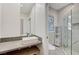 Modern bathroom with marble shower, unique stained glass window and floating vanity at 8051 Castle Pines Ave, Las Vegas, NV 89113