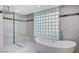 Modern bathroom featuring glass shower and free-standing tub with marble accents at 8051 Castle Pines Ave, Las Vegas, NV 89113