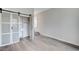 Bedroom featuring wood floors and barn door closet with built-ins at 8051 Castle Pines Ave, Las Vegas, NV 89113