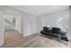 A bright bedroom features a black futon, a modern closet, and light wood flooring at 8051 Castle Pines Ave, Las Vegas, NV 89113
