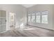 Bright bedroom featuring wood floors, a view of nature and an ensuite bathroom at 8051 Castle Pines Ave, Las Vegas, NV 89113