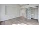 Neutral bedroom featuring wood floors and barn door closet at 8051 Castle Pines Ave, Las Vegas, NV 89113