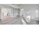 Bright bedroom featuring wood floors and barn door closet with an ensuite bathroom at 8051 Castle Pines Ave, Las Vegas, NV 89113
