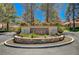 Beautifully landscaped community entrance with 'Links' sign set in a circular stone feature at 8051 Castle Pines Ave, Las Vegas, NV 89113