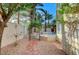 Private courtyard featuring lush greenery, an arched gate, and stone accents at 8051 Castle Pines Ave, Las Vegas, NV 89113