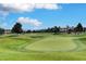 Expansive golf course view with rolling hills, sand traps, and a well-manicured green, perfect for golfing enthusiasts at 8051 Castle Pines Ave, Las Vegas, NV 89113