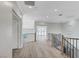 Bright hallway features wood floors, modern lighting, and stylish railing at 8051 Castle Pines Ave, Las Vegas, NV 89113
