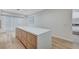 Bright kitchen featuring an island with light countertops, ample storage, and modern fixtures at 8051 Castle Pines Ave, Las Vegas, NV 89113