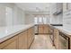 An open kitchen features an island and stainless steel appliances at 8051 Castle Pines Ave, Las Vegas, NV 89113