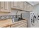 Bright laundry room featuring a stainless steel sink, butcher block countertops, and modern appliances at 8051 Castle Pines Ave, Las Vegas, NV 89113