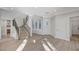 Bright living room featuring staircase, modern floors, and large windows at 8051 Castle Pines Ave, Las Vegas, NV 89113