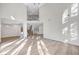 Bright and airy living room featuring soaring ceilings, modern wood floors, and an open layout perfect for entertaining and relaxing at 8051 Castle Pines Ave, Las Vegas, NV 89113