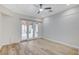 Bright living room with French doors leading to an outdoor patio and new hardwood floors at 8051 Castle Pines Ave, Las Vegas, NV 89113