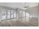 This wide-open living space boasts a modern fan and a lovely back patio entrance at 8051 Castle Pines Ave, Las Vegas, NV 89113